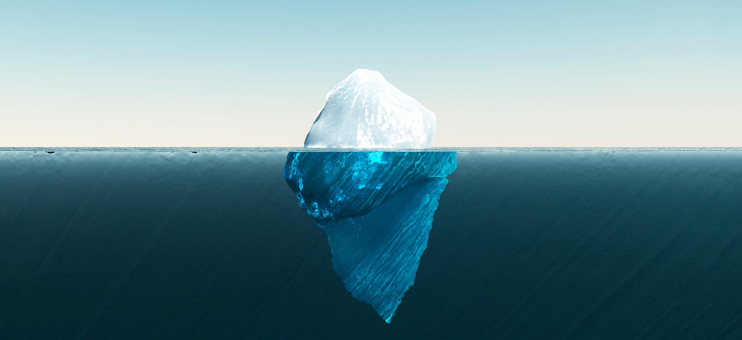 Photo of an iceberg showing above and below water level